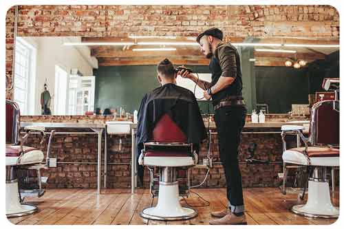 hairdresser serving client at barber shop.