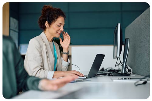 consultant using laptop while having customer call in the office