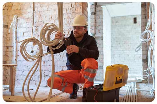 electrician installing wiring in building, electrician insurance