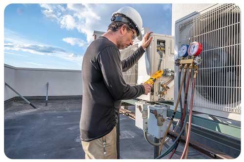 HVAC technician taking an amperage reading on a air conditioning system.
