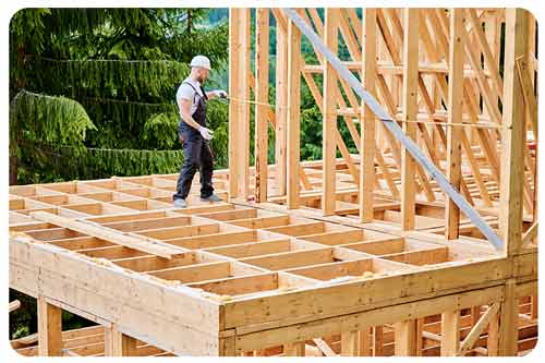 Carpenter working on wooden frame construction, carpenters insurance