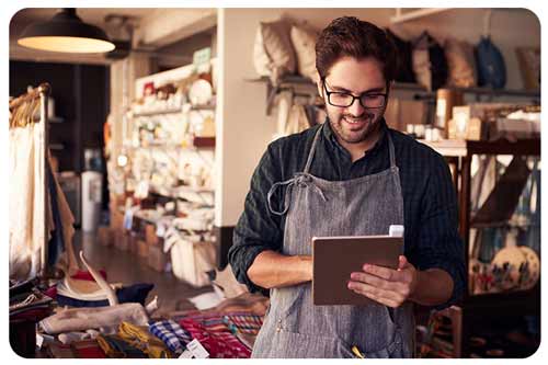 owner using ipad in his gift store