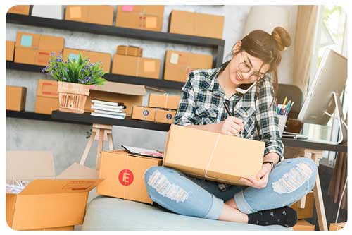 Woman working from home business getting packages ready