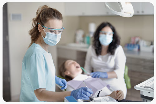 A female dentist is treating a patient.