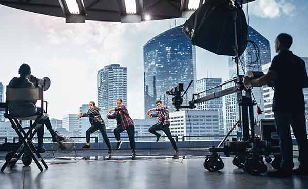 shooting video dance scene with dancers performing on stage