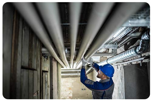 plumber inspecting, ceiling pipes, plumbing insurance
