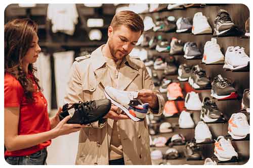 A male customer and store assistant choosing sneakers.