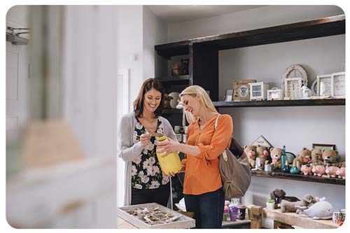 Two women are looking at products in a shop