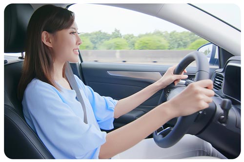an asian woman driving a car