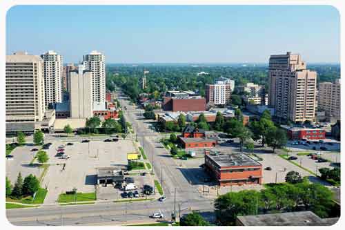 A black SUV car is waiting for traffic signal at an intersection in London, Ontario