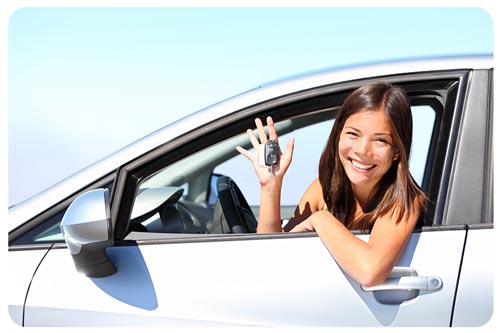 new car driver smiling and showing new car keys