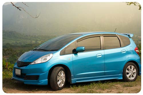 Blue car surrounded by mountain