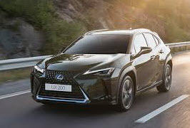 Black Lexus driving down the road
