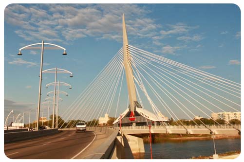 car drivng on walkway bridge over Red River