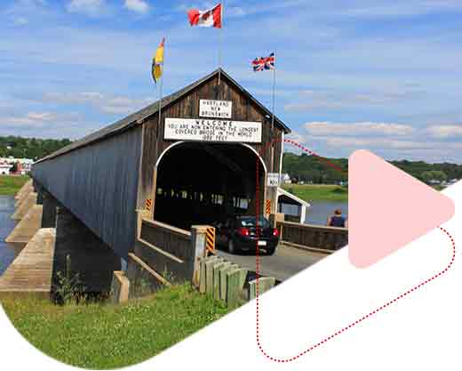 a car passing by The longest wooden covered bridge