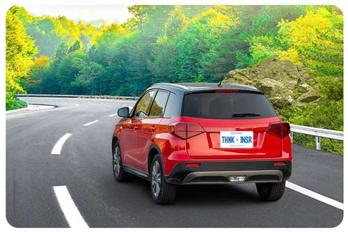 red car driving on the road