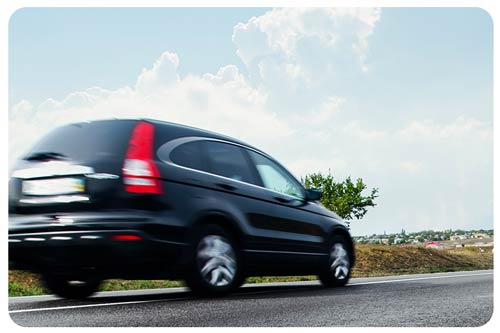 black suv driving on the road