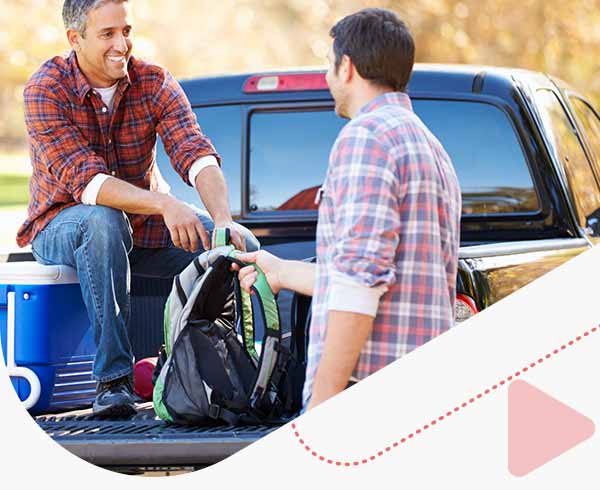 Man sitting in back up pick up truck