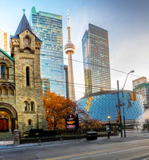 Toronto road view of St Andrew's Presbyterian Church and CN Tower