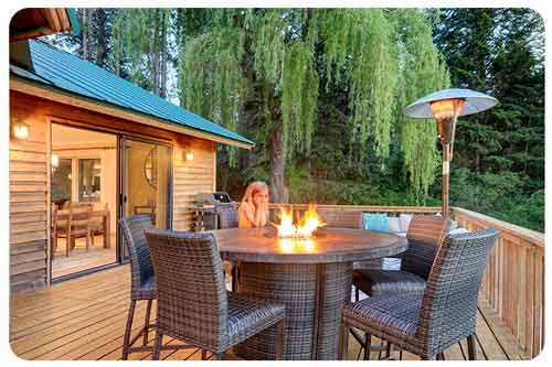  girl sitting near fire pit on outdoor furniture