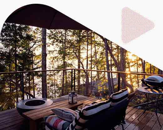 a deck at a cottage looking at the water