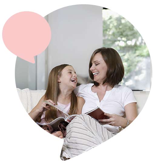 mother and daughter on sofa in living room