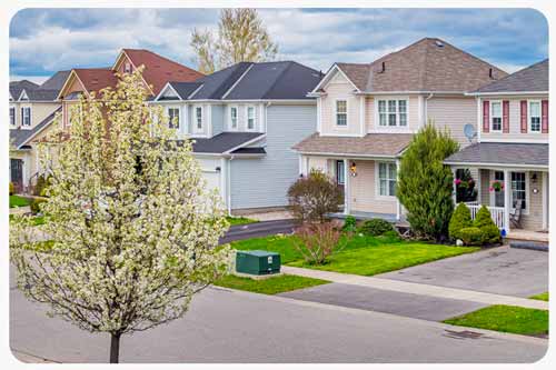a suburban neighbourhood with rows of houses featuring similar architectural styles.