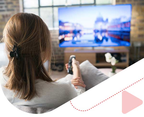 woman watching TV in her home