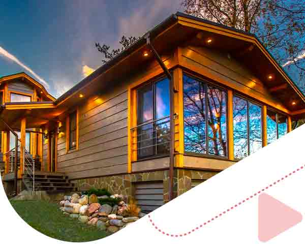wood pannel cottage with large windows
