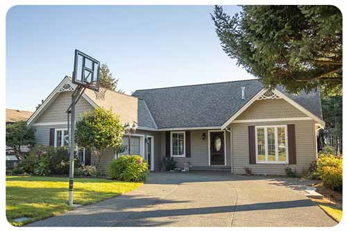 home with basketball hoop in driveway