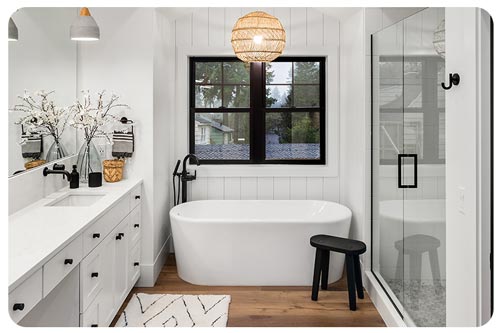 bathroom in home with bathtub, sinks, shower, and hardwood floor