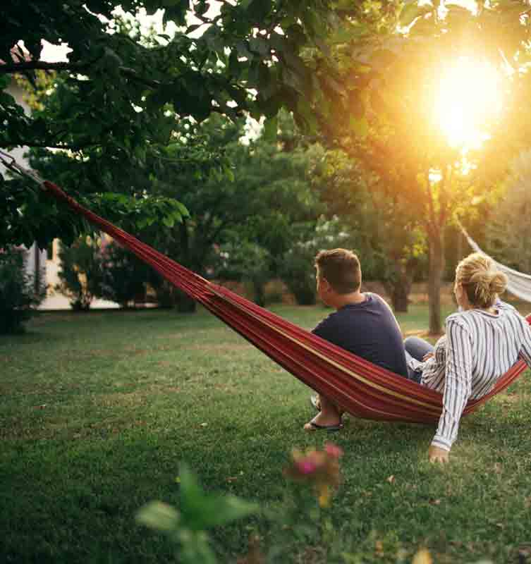 a couple sitiing on hammock