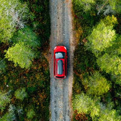 Red car driving in the country