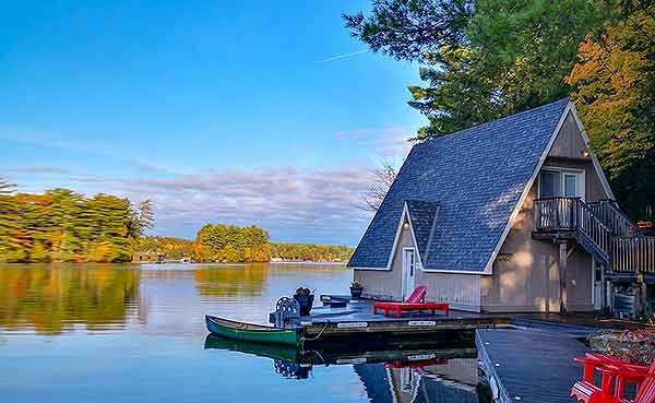 A frame cottage and dock on the water