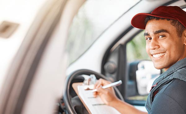 delivery car and man with clipboard paperwork