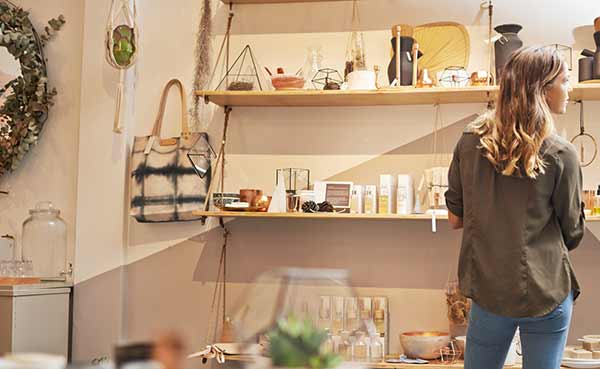 a young woman looking at products on a shelf in a store