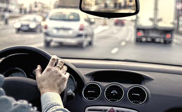 Inside view from a car of a driving on the highway