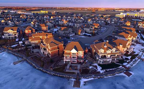 houses in winter at sunrise overlooking Lake Summerside, Edmonton