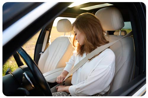 a woman fastening her seat belt