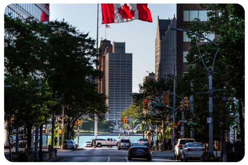 woman standing beside her car