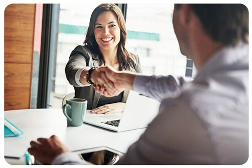 insurance broker shaking hands with a client