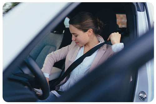a woman giving seat belt in car