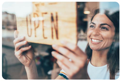 owner setting open sign at the shop glasses