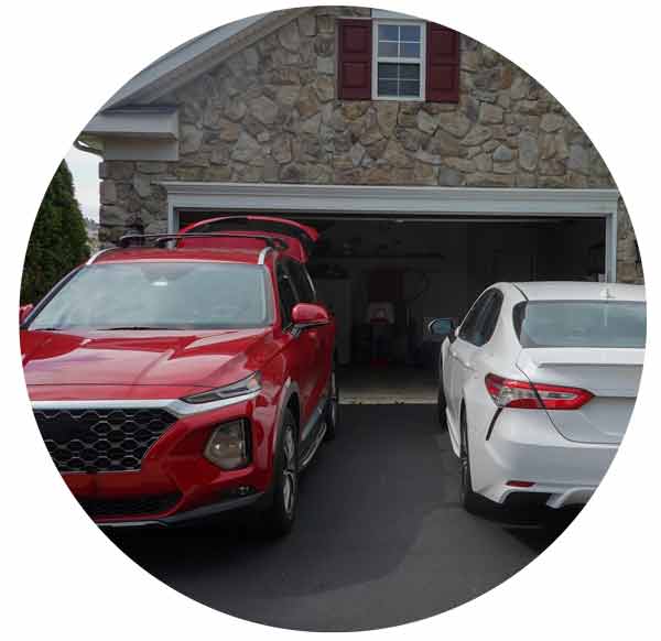 red SUV and white car parked in the driveway.