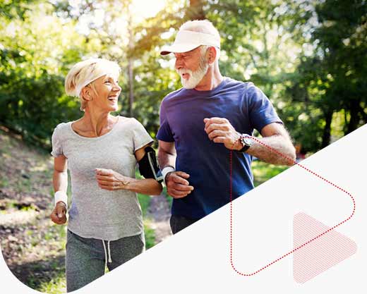 senior couple jogging and running outdoors in nature
