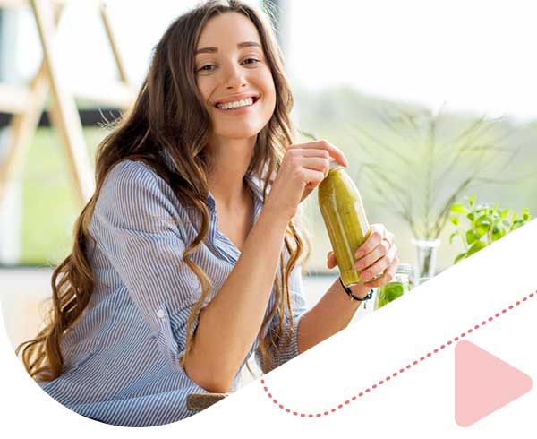 happy woman sitting with a drink at home