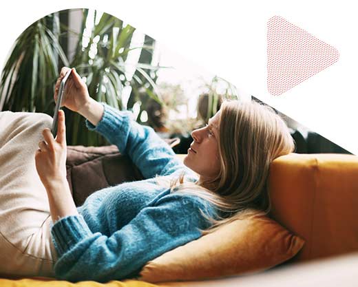 a woman lying on a comfortable sofa in the living room