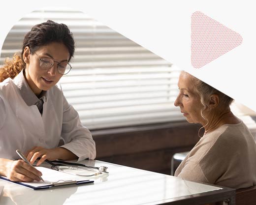 a doctor writing notes with an older female  patient