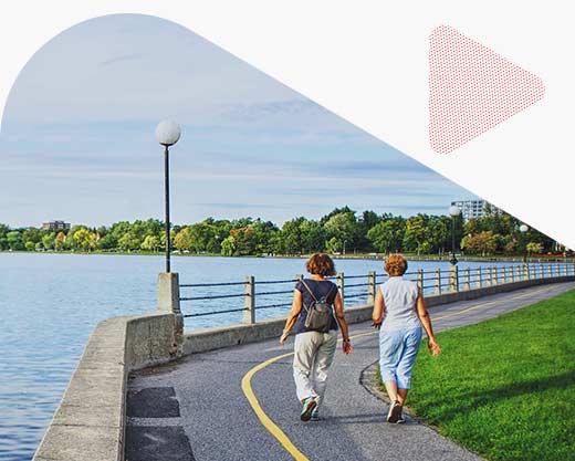 two women walking along the Rideau Canal