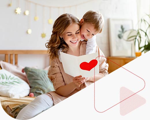 a mother and son looking at a card with a heart on it